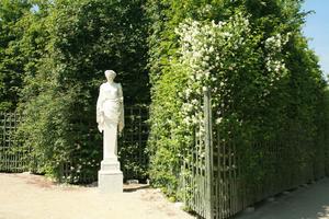 architecture, bush, day, eye level view, France, Ile-De-France, landmarks, object, Palace of Versailles, Paris, park, sculpture, spring, summer, sunny, vegetation