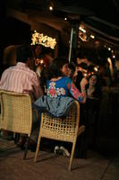 artificial lighting, back, bar, cafe, chair, couple, eye level view, Florida, furniture, man, Miami, night, sitting, table, The United States, winter, woman